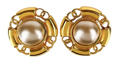 Lot 534 - A Chanel 24ct gold-plated pair of CC and faux pearl clip earrings, circa 1990.