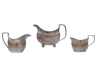 Lot 10 - A George III silver milk jug, and two other silver milk jugs.