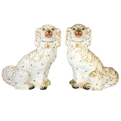 Lot 372 - A pair of large fireside Staffordshire pottery spaniels.