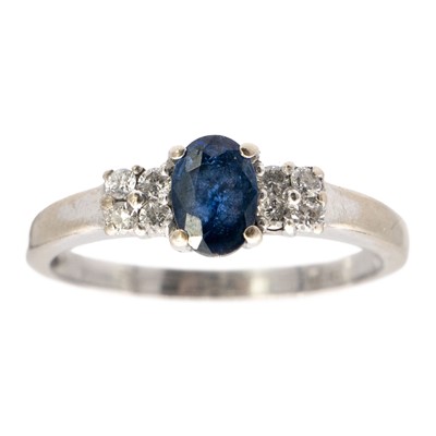 Lot 247 - An 18ct white gold diamond and sapphire ring.