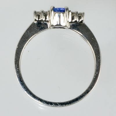 Lot 29 - A modern 9ct white gold tanzanite and diamond set ring.