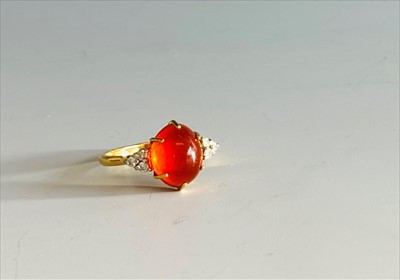 Lot 2449 - An 18ct gold fire opal ring each shoulder with...