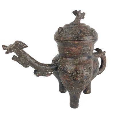 Lot 1121 - A Chinese archaic style bronze pouring vessel.