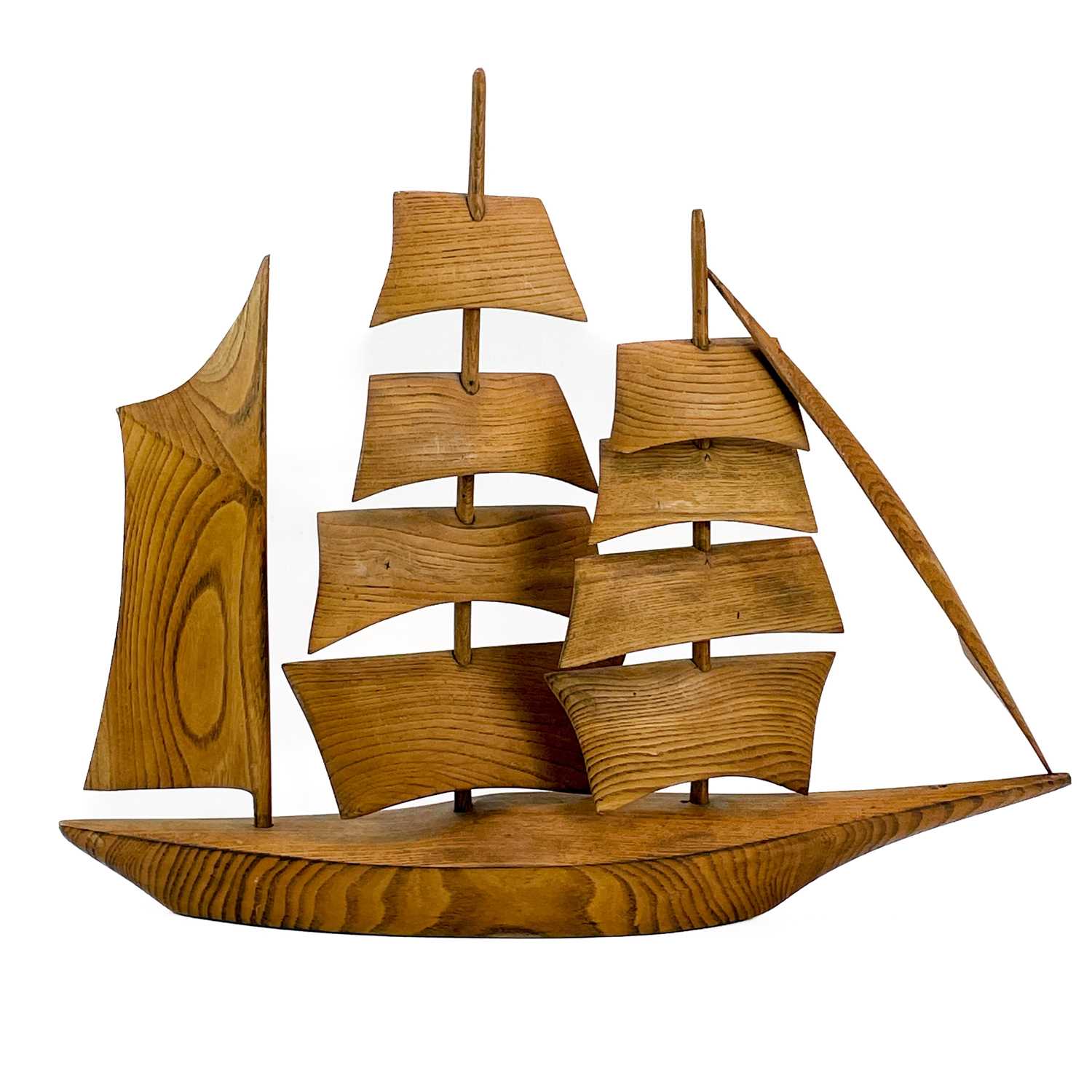 Lot 148 - A Cornish carved elm model of a sailing ship.