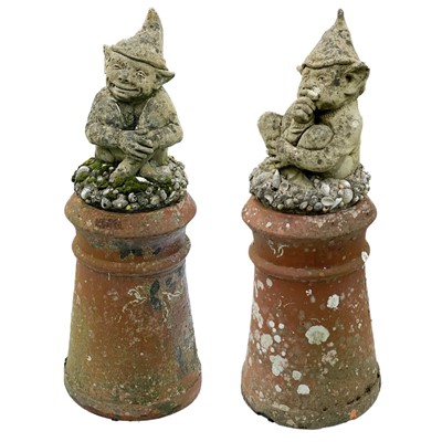 Lot 351 - A pair of reconstituted stone Cornish Piskies on shell encrusted bases.