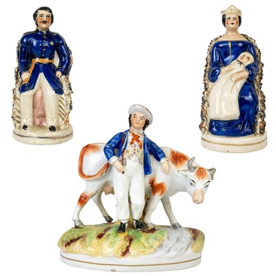 Lot 354 - A Staffordshire pottery group figure of a farmer and a bull.