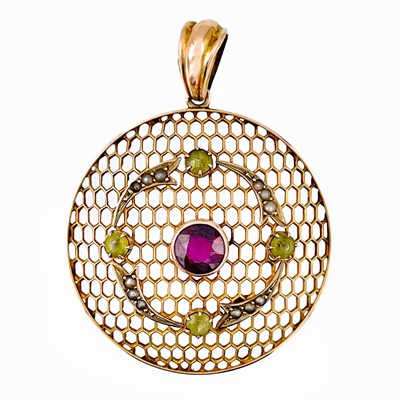 Lot 32 - An Edwardian Suffragette 9ct gold pendant set with a pyrope garnet, peridot and seed pearl.