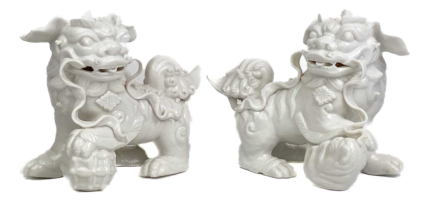 Lot 1167 - A pair of Chinese blanc de chine dogs of fo, 19th century.