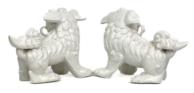 Lot 1167 - A pair of Chinese blanc de chine dogs of fo, 19th century.