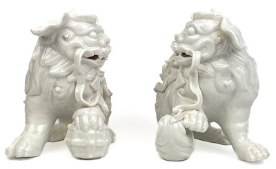 Lot 1167 - A pair of Chinese blanc de chine dogs of fo, 19th century.