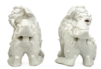 Lot 1167 - A pair of Chinese blanc de chine dogs of fo, 19th century.