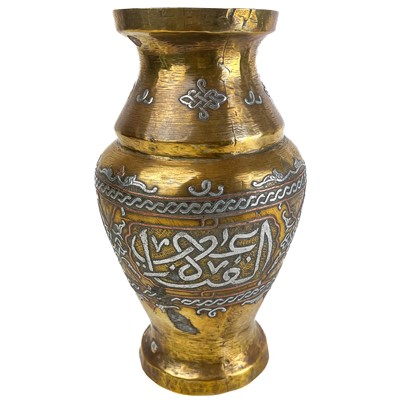 Lot 21 - A Cairoware brass and silver inlaid vase, Egypt, circa 1900.