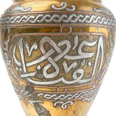 Lot 21 - A Cairoware brass and silver inlaid vase, Egypt, circa 1900.