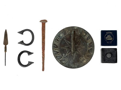 Lot 135 - A bronze circular sundial with gnomon and compass rose decoration.