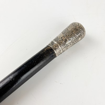 Lot 59 - An early 20th century ebonised silver top walking cane.