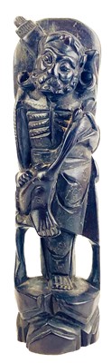 Lot 1221 - A Chinese carved wood figure of a fisherman, late 19th century.