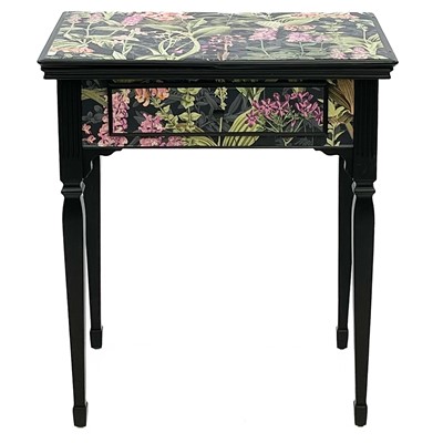 Lot 676 - A black painted side table with floral vinyl wrap decoration.