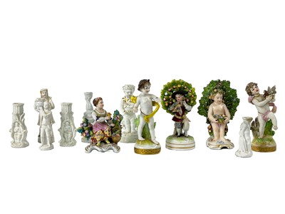 Lot 422 - A Derby porcelain figure of a putti holding a basket of flowers.