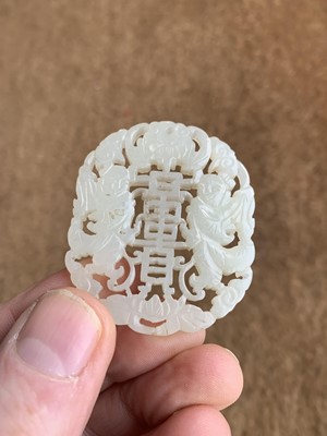 Lot 1295 - A Chinese carved jade pendant.