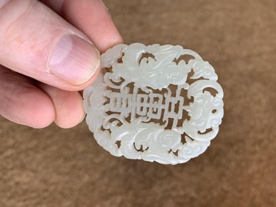 Lot 1295 - A Chinese carved jade pendant.