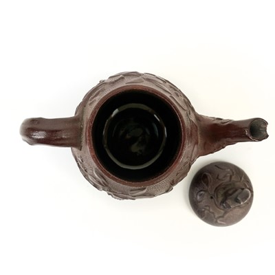 Lot 42 - A brown/red stoneware small teapot.