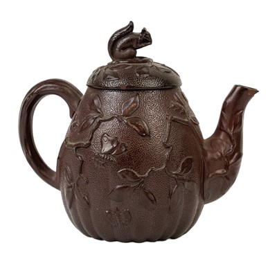 Lot 42 - A brown/red stoneware small teapot.