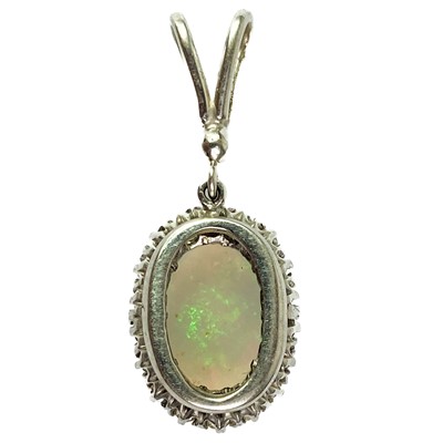 Lot 41 - A white opal and diamond cluster white gold pendant.