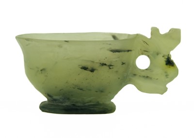 Lot 4 - A small Chinese jade and black nephrite libation cup, Qing Dynasty.