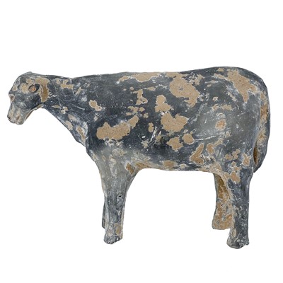 Lot 1385 - A Chinese pottery model of a cow, Han Dynasty or earlier.