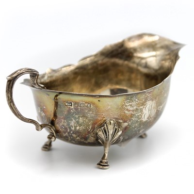 Lot 17 - An Edward VII silver sauce boat by Walker and Hall.