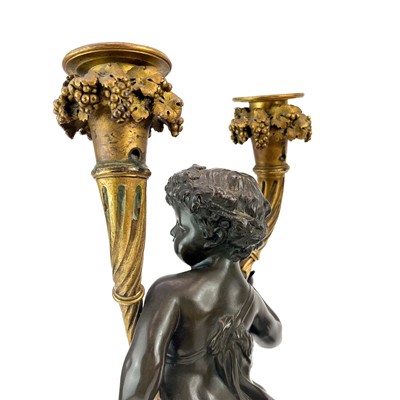 Lot 3 - A pair of French bronze and ormolu figural candelabra, after Clodion.