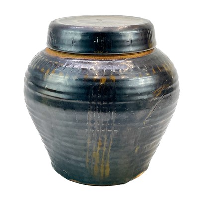 Lot 570 - A studio pottery jar with a screw lid.