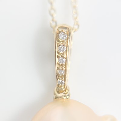 Lot 40 - A contemporary 18ct pendant with a suspended large Baroque cultured pearl and with diamond set bale.