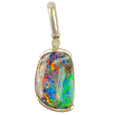 Lot 157 - A contemporary 18ct white gold, black boulder opal and diamond set pendant.