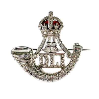 Lot 24 - A 9ct white diamond set and red enamel WWII Durham Light Infantry sweetheart brooch.