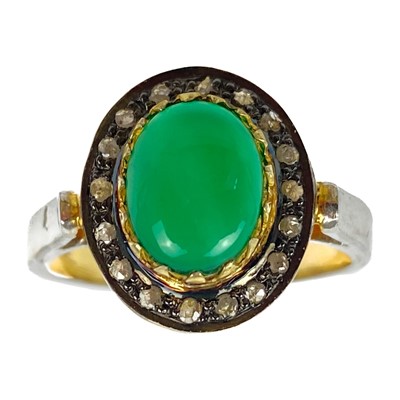 Lot 119 - An antiques style silver and gilt cabochon green onyx and diamond set halo ring.