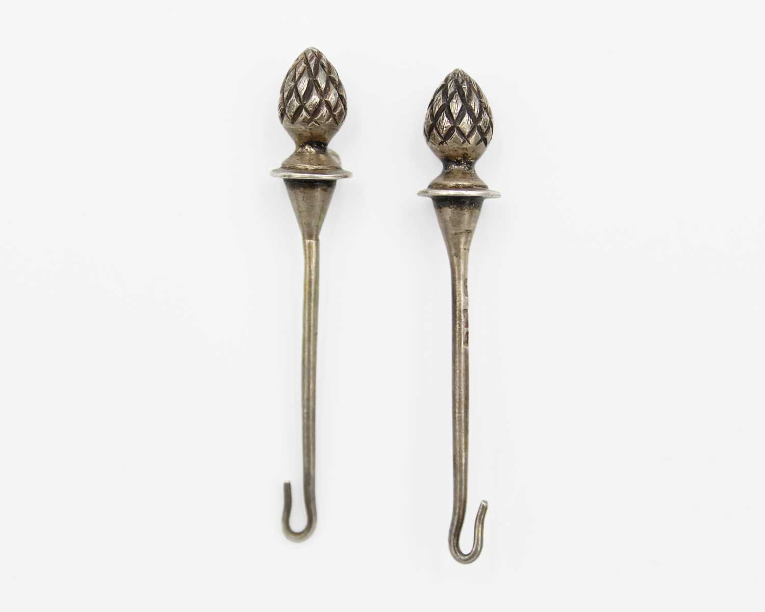 Lot 166 - A pair of silver button hooks.