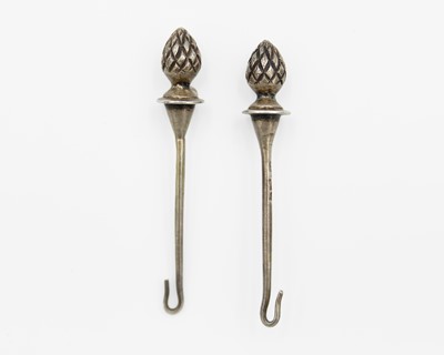 Lot 166 - A pair of silver button hooks.