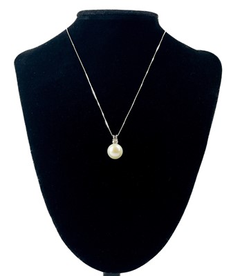 Lot 169 - A 9ct white gold cultured pearl and diamond bale pendant necklace.