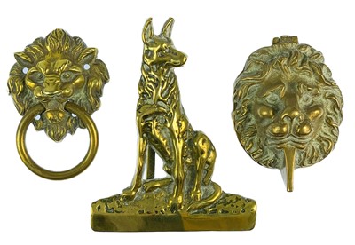 Lot 82 - A collection of nine novelty brass door knockers.