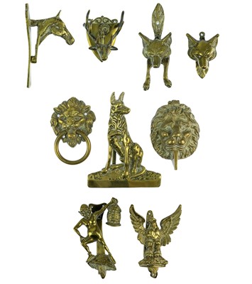 Lot 82 - A collection of nine novelty brass door knockers.