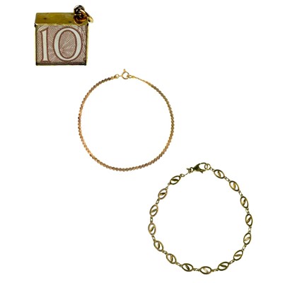 Lot 73 - Two 9ct bracelets and a 9ct 10/= note charm.