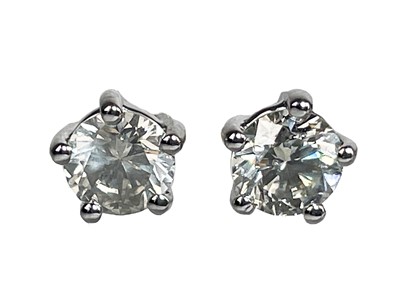 Lot 284 - A pair of certified diamond set solitaire stud earrings.