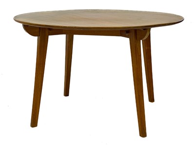 Lot 653 - A mid century teak circular dining table.