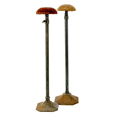 Lot 39 - A pair of cast metal and tubular milliners adjustable hat stands.