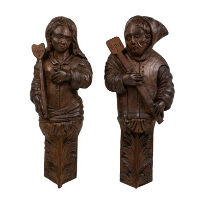 Lot 353 - A pair of late 19th century Continental oak carved wall hanging figures.