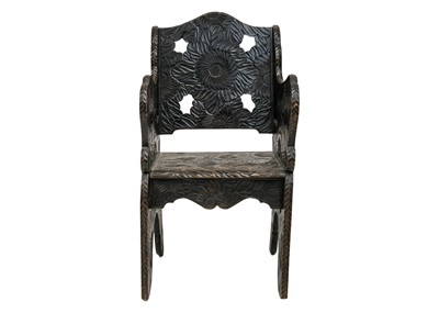 Lot 620 - A Japanese Arts and Crafts floral carved armchair.