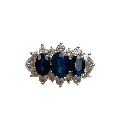 Lot 356 - An 18ct white gold blue sapphire and diamond triple cluster ring.