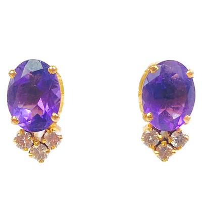 Lot 328 - A pair of 18ct amethyst and diamond set screw back earrings.