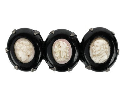 Lot 35 - A Victorian triple shell cameo and jet silver mounted brooch.
